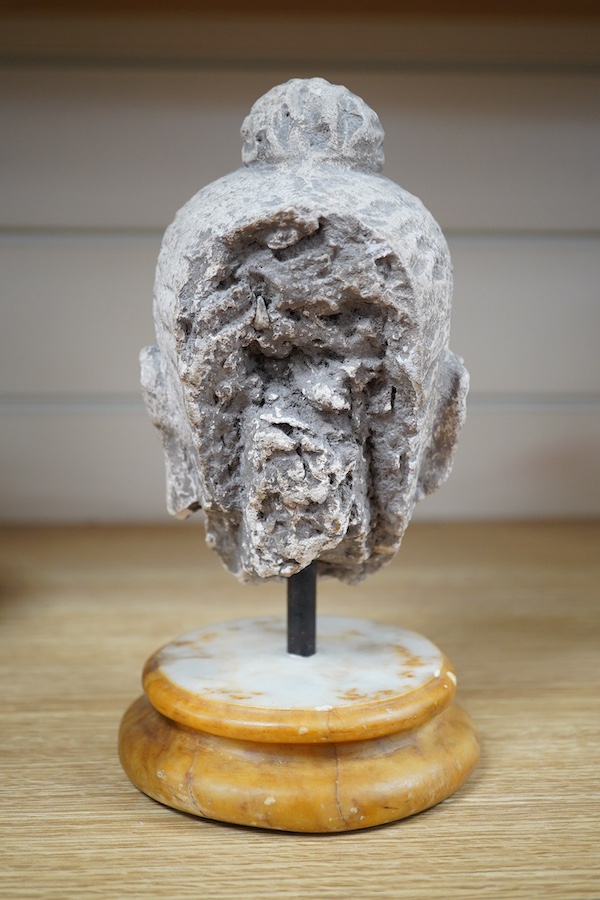 A stucco work head of Buddha, on marble stand, 21cm. Condition - fair